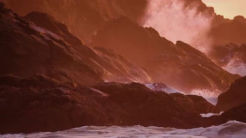 Ocean Waves Crashing On The Rocky Coastline And Cliffs During Golden Hour. - slow motion, zoom in sh