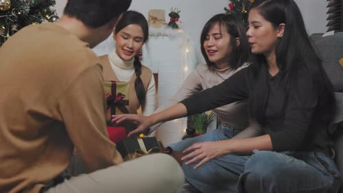 Friends Exchanging Gifts During Christmas Celebration
