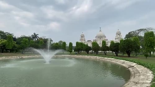 Panning shot of Landscape View of The Victoria Memorial , a large marble building in Central Kolkata