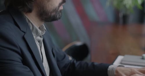 Closeup of Ambitious Middle Eastern Businessman Typing with Laptop Computer Working Indoors in Cafe