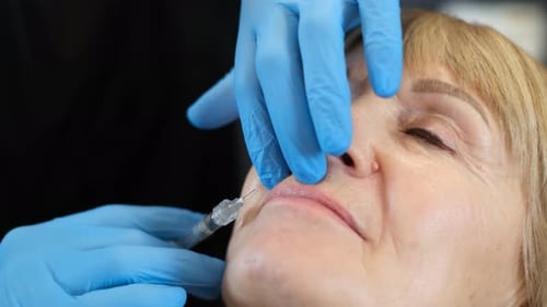 Woman Receives Lip Injection in Medical Clinic