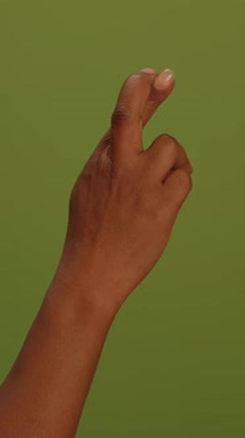 Hand with Fingers Crossed on Green Screen