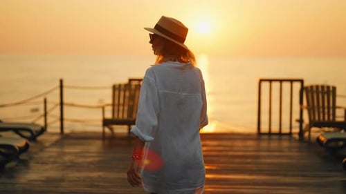 Traveling and Resting on Seacoast Woman on Pier in Sunset or Sunrise Time Beautiful Seascape and