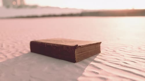 Old Book on the Sand Beach