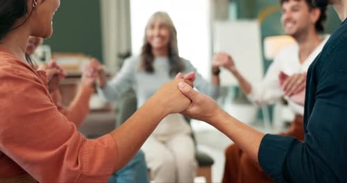 Group Holding Hands Together in Support Circle