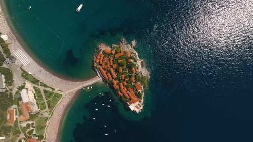 A drone view from above of the island of Sveti Stefan in Montenegro, connected to the mainland by a