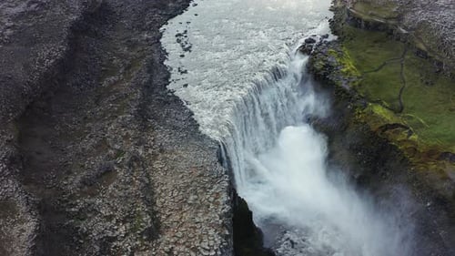 Waterfall Cascading Over Rocky Cliffside From Above