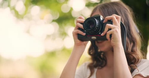 Woman Taking Picture with Camera in Green Nature