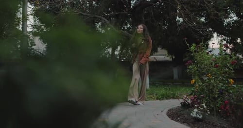 Woman Walking in the Autumn Park