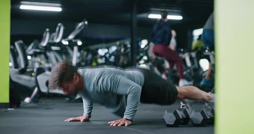 Athlete, push ups and man in gym, fitness or training for muscle strength