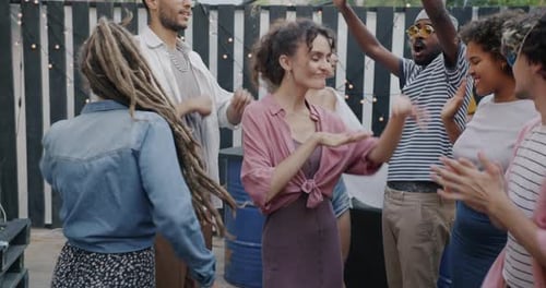 Friends Dancing and Celebrating at Rooftop Party