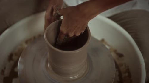 Potter Shaping Clay Vase on Pottery Wheel