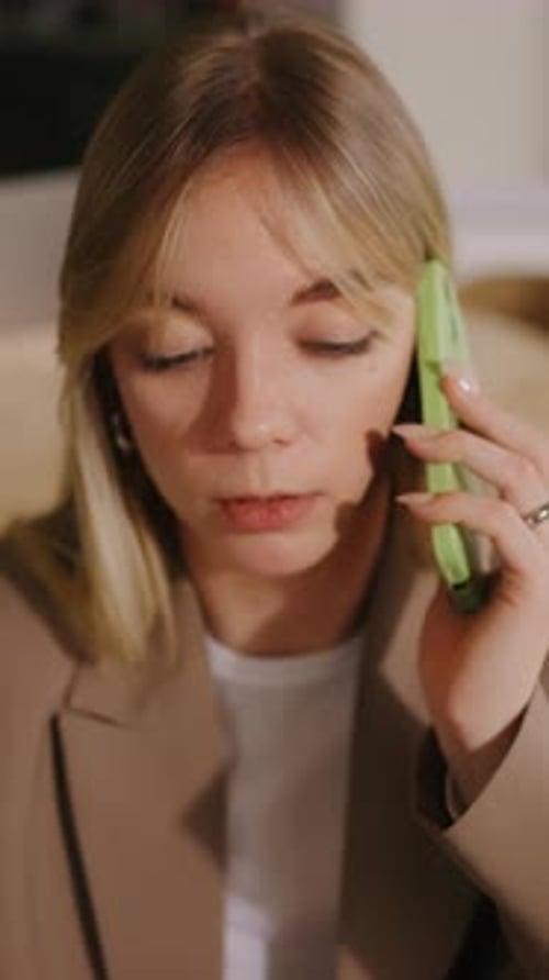 Woman on Phone in Office Talking with Laptop