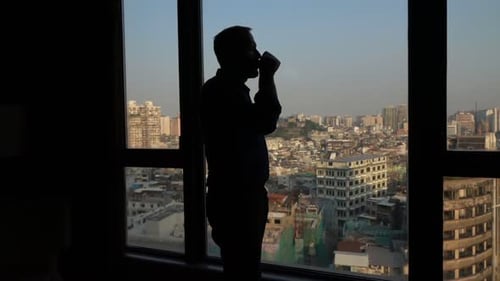 Silhouette of Man with Beverage Admire View From Window at Home, Super