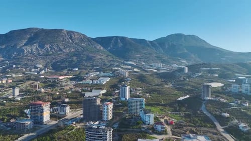 Aerial Video of a Green City Panorama With Lush Parks and Urban Buildings Against a Majestic