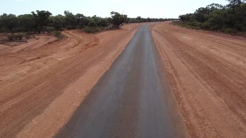 Drone flying over a sealed country road at low altitude in the Australian Outback