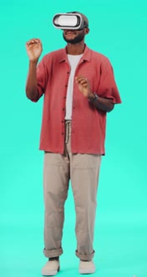 Young Man Using VR Headset Interacts with Hands