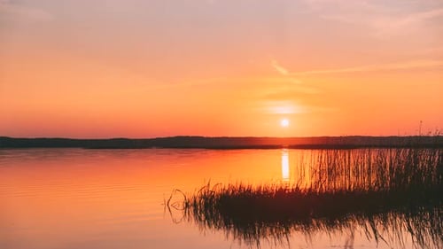 Sundown Above Lake River Horizon At Sunset