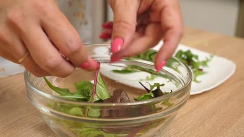 99. Place the lettuce leaves in a clear glass bowl.