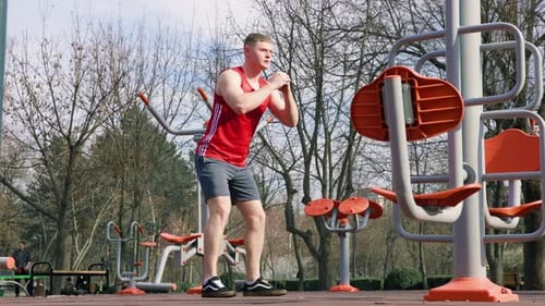 Man Doing Squats in Fitness Park Area
