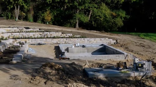 Construction Site Construction of a Swimming Pool Near a Private House Drone Wide Shot