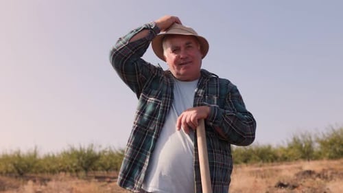 Adult Farmer Outdoors Holding Gardening Tool
