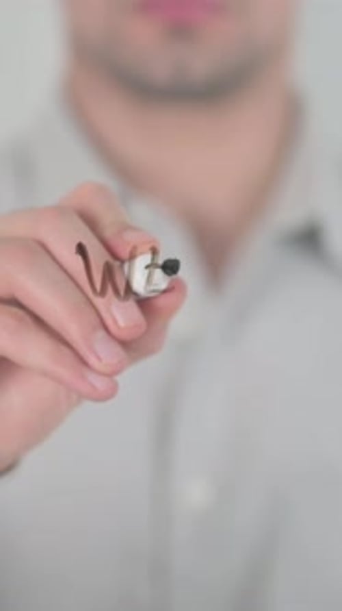Man Writes 'Web Analytics' on Glass Surface