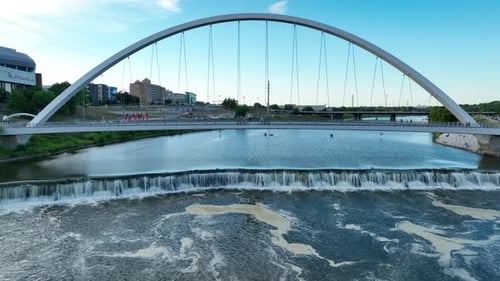Pedestrian bridge crossing Des Moines River. Aerial rising shot of Iowa Women of Achievement Bridge