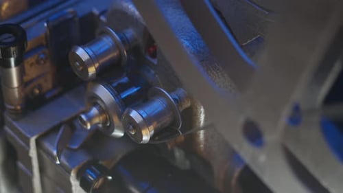 Closeup View of Reels of Old 16Mm Film Projector Under Blue Lighting Playing Old Vintage Film on