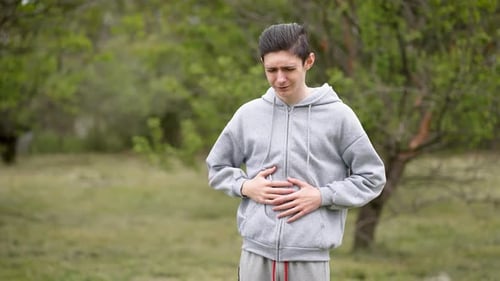 Teenage Boy Writhing in Stomach Pain Dealing with Intestinal Issues Infections and Diarrhea