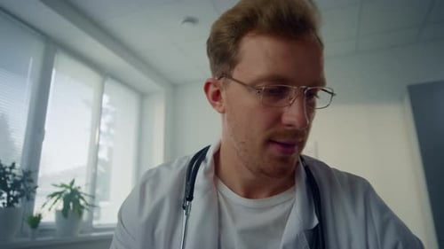 Pov Video Smiling Physician Completing Patient Examination in Modern Clinic. First Person