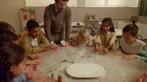 Children observe science experiment with dry ice in classroom