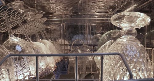 Close Up of Dishwasher Spraying Water on Glasses