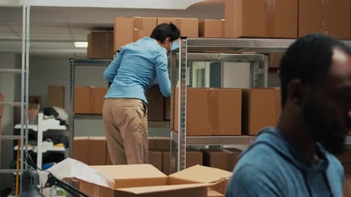 African American Man Scanning Warehouse Produucts with Tablet and Scanner