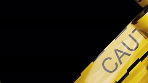 Rolling out a lot of warning tapes with yellow and black diagonal stripes.