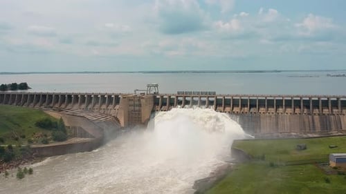 Revealing shot of lake behind reservoir wall with open sluice gates. Vaal dam, South Africa