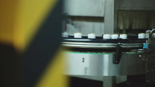 white beverage cans on a factory production line