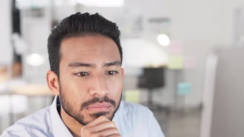 Business man analyzing project strategy on a computer screen while working in an office