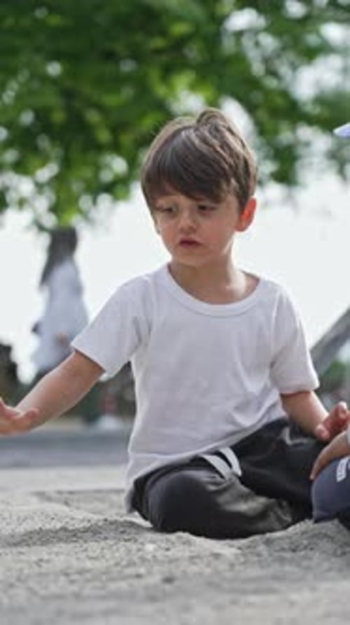 Little Boy Playing In Sand Playground With His Fully Loaded Toy Truck - Building Games With Sand