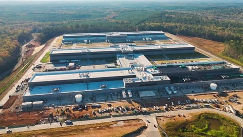 Aerial View of Construction Site with Assembly of Modern Large Factory Structure for Production and