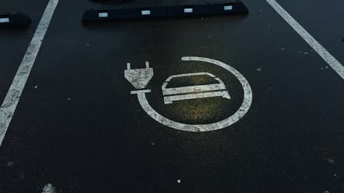 The Electric Vehicle Charging Station Symbol Displayed Prominently on the Surface of a Parking Lot