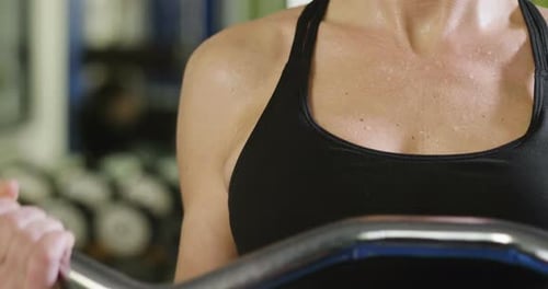 Close up of the body of a sporty and fit woman, who recovers her energy after sweating at the end