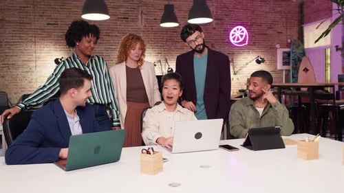 Diverse Team Collaborating Around Conference Table in Modern Office