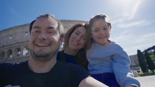 Happy Family Posing in front of the Colosseum