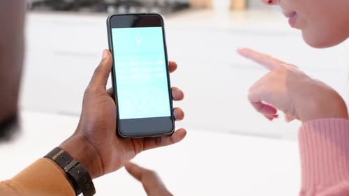 People using cell phone to control home technology