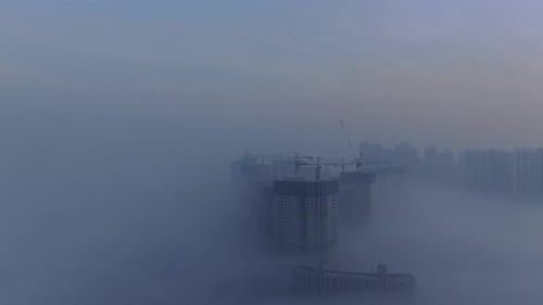 A city that seems to be floating in the air with fog and dust.