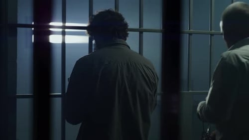 Jailer Opens Prison Cell with Keys and Locks Criminal Inside