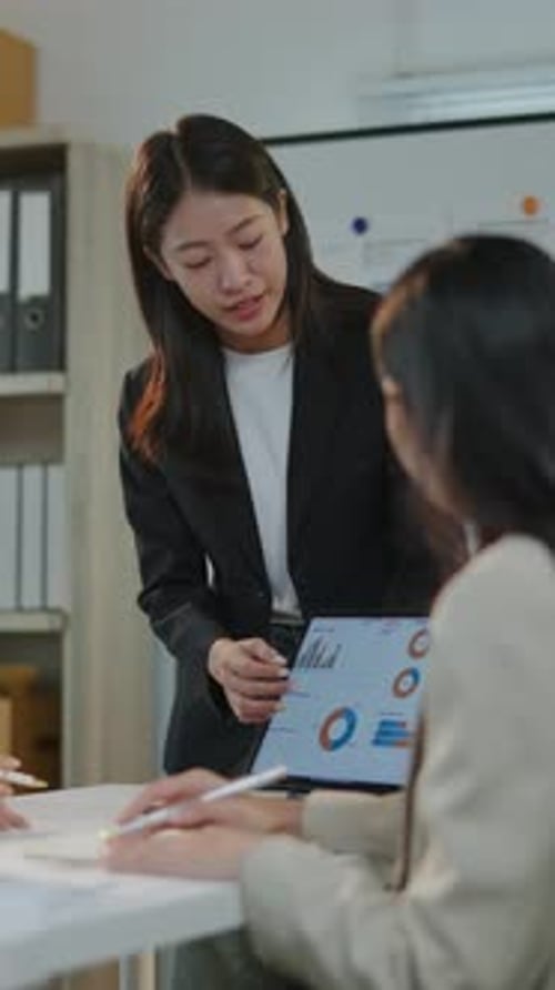Women Collaborate on Data at Office Meeting