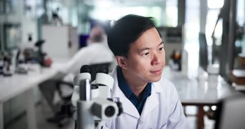 Scientist Using Microscope in Bright Laboratory