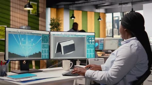 Smiling Engineer in Office Pleased After Developing Innovative Solar Device